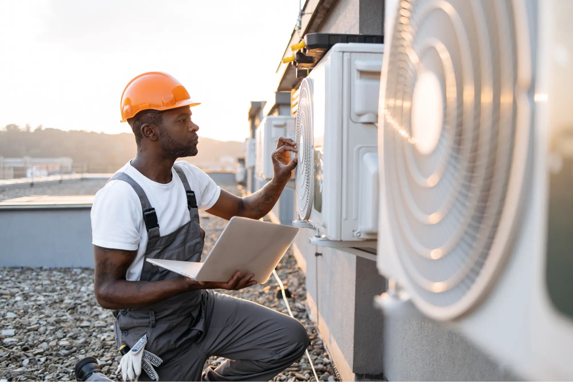 img hvac technician working on roof